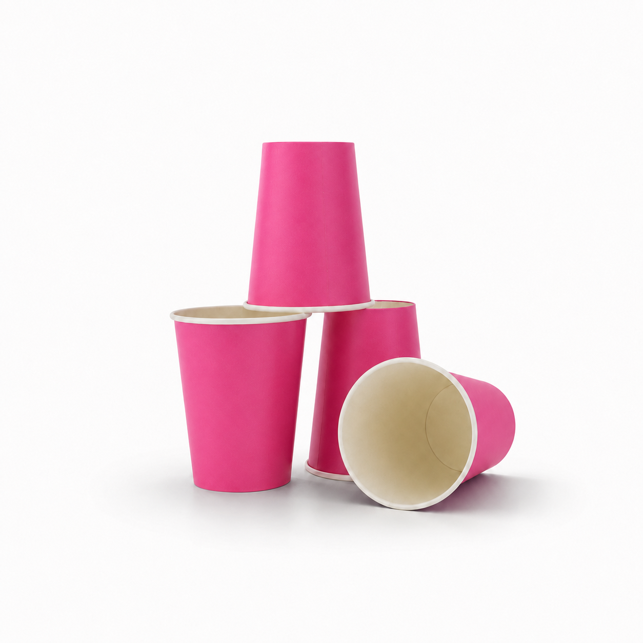 Three Hot pink paper cups arranged on a clean white background, with one standing upright, one lying on its side showing the beige interior, and one standing behind the others.