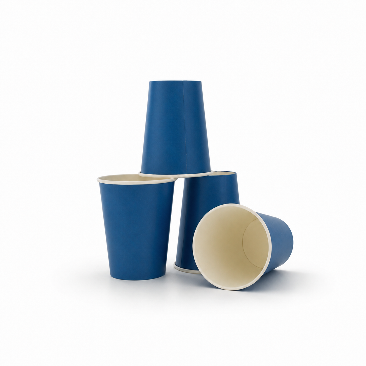 Three blue paper cups with cream-colored interiors, arranged in a stack and lying down on a white background.