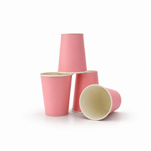 Four pink paper cups with cream-colored interiors, arranged in a stack and on a plain white background.