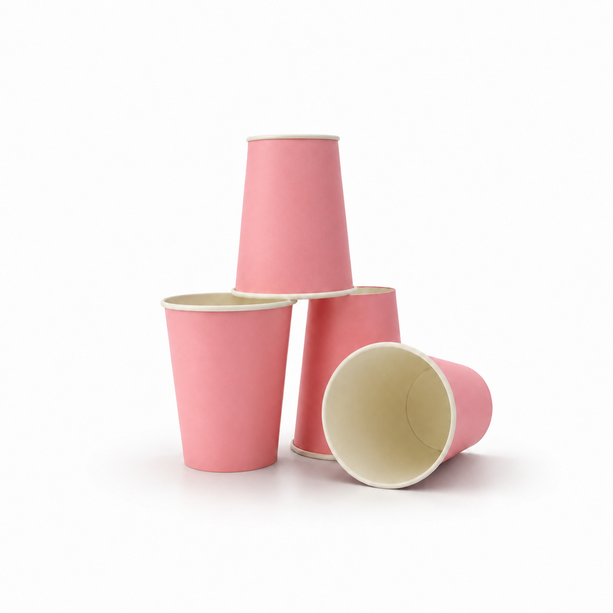 Four pink paper cups with cream-colored interiors, arranged in a stack and on a plain white background.