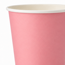 A close-up of a pink paper cup with a white rim, showing the interior side against a plain white background.